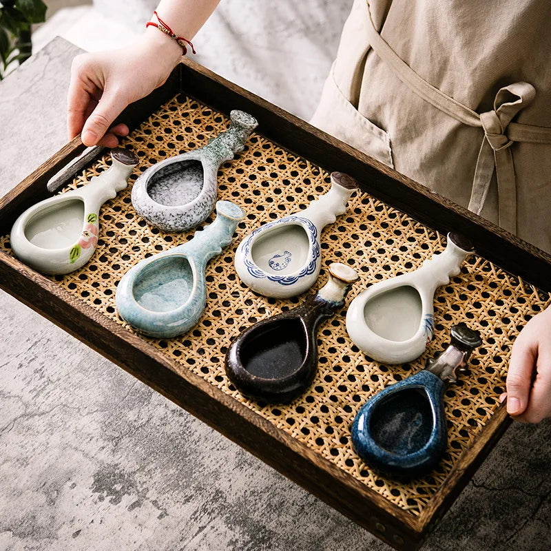 Ceramic brush rest and ink dish – all designs displayed on rattan tray, lifestyle shot