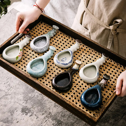 Ceramic brush rest and ink dish – all designs displayed on rattan tray, lifestyle shot