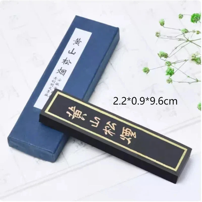 Pine smoke ink block displayed with inkstone in calligraphy desk setup