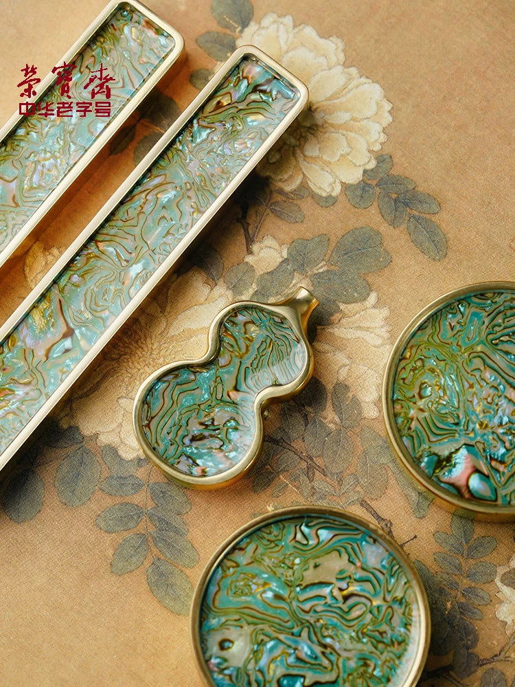 Rongbaozhai brass paperweight styled on a calligraphy desk with ink and brush