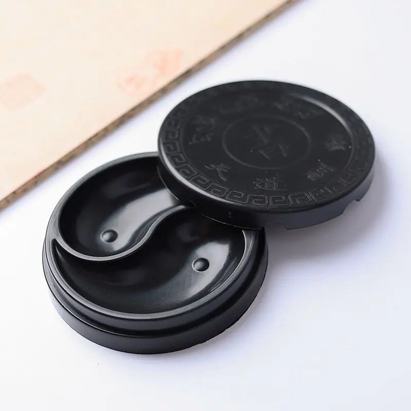 Close-up of Yin Yang symbol on calligraphy ink tray surface