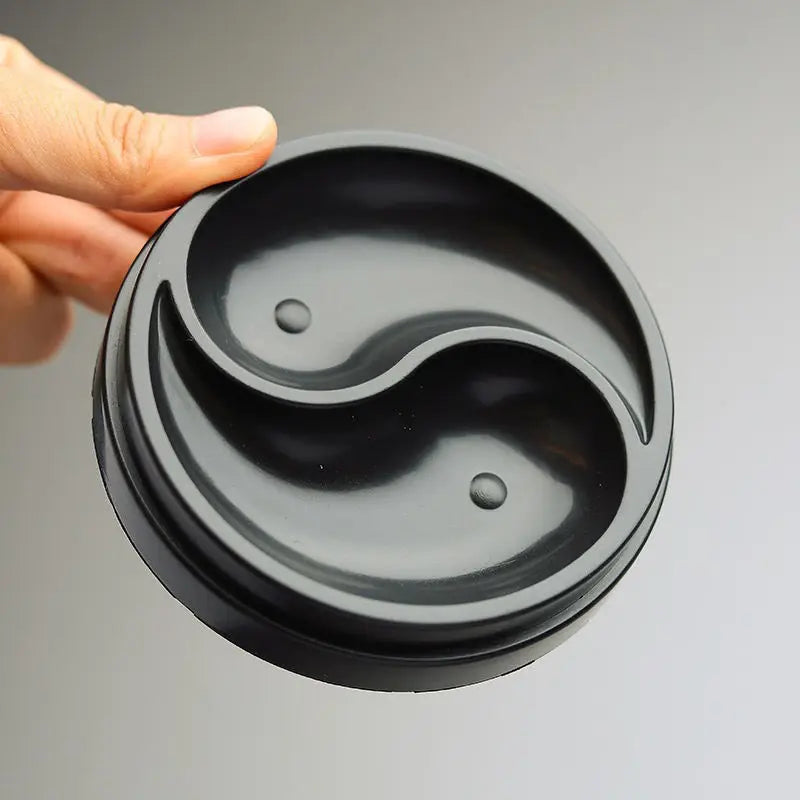 Side view of plastic Tai Ji calligraphy ink tray