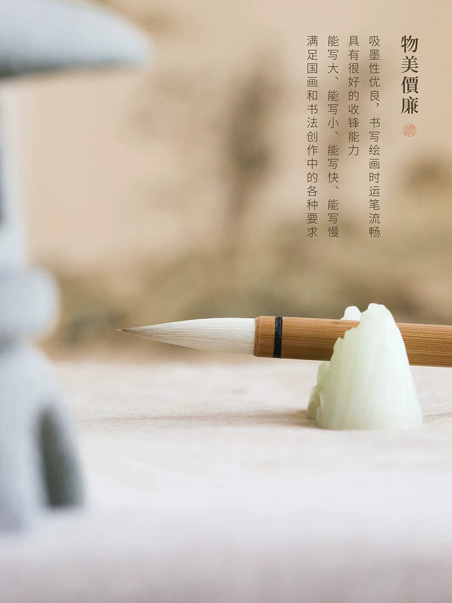 Wen Xin Tang Bai Yun Chinese painting brush resting horizontally on a pale ceramic brush rest