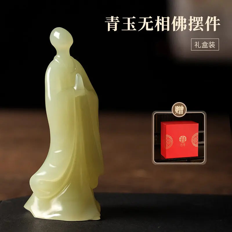 A pale translucent jade-like standing Buddha figurine shown on a dark surface against a dark background, with Chinese text and a small inset showing a red gift box included with the purchase.